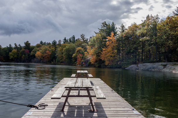picnic tables on the dock at the lake - Photo, Image