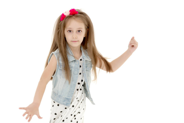 A cheerful little girl is dancing. - Φωτογραφία, εικόνα