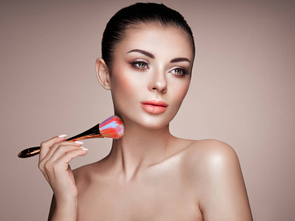Beautiful Woman applies Skin Tone with Brush - Foto, Imagem