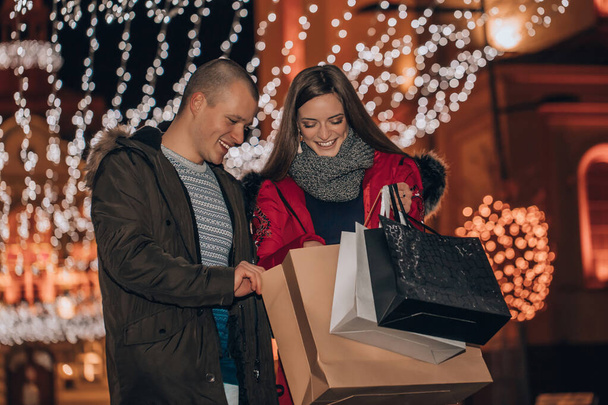 若い陽気なカップル保持プレゼントでショッピングバッグとha - 写真・画像