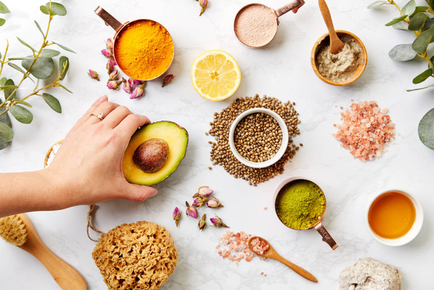 Overhead View Hand Arranging Natural Beauty And Health Products On Marble Background - Foto, Imagem