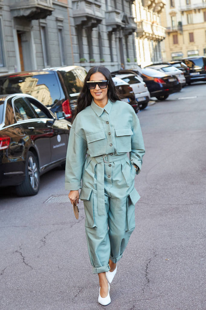 Woman with green blue overalls and sunglasses before Salvatore Ferragamo fashion show, Milan Fashion Week street style  - Φωτογραφία, εικόνα