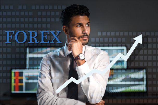 pensive bi-racial trader looking away near forex letters in office  - Photo, Image