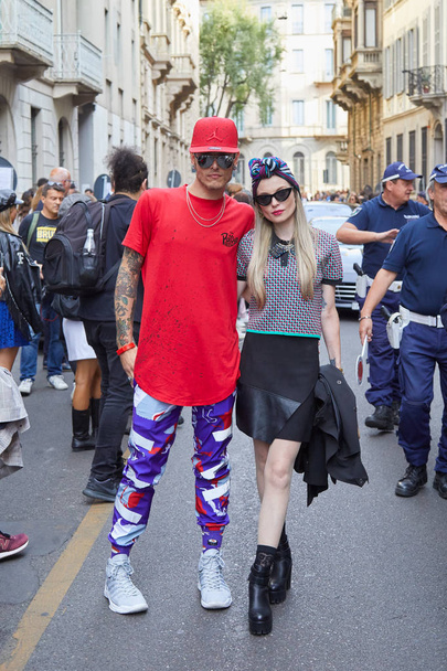 Man and woman with red shirt and headscarf before Giorgio Armani fashion show, Milan Fashion Week street style  - Фото, зображення