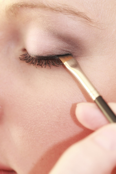 Part of face female eye makeup applying with brush - 写真・画像