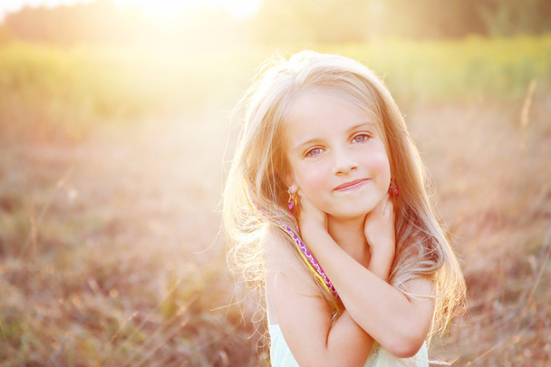 Happy little girl on summer meadow - Фото, зображення