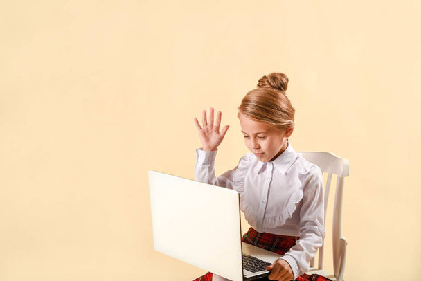 little business girl write in notepad. Business style clothing, plaid skirt, white blouse. Work at the laptop. Emotional child, laughs and screams. Surprise and bewilderment - Photo, image