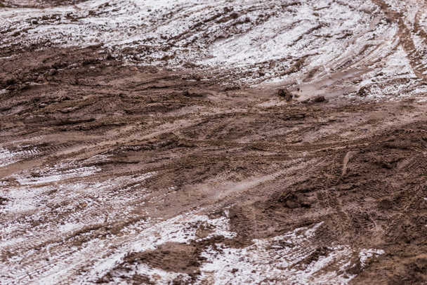 dirty mud road background at winter with selective focus and blur - Photo, Image