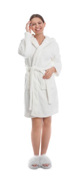 Young woman in bathrobe on white background - Fotoğraf, Görsel
