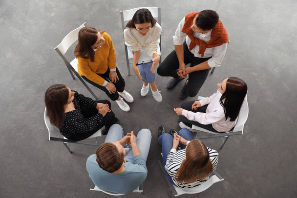 Psychotherapist working with patients in group therapy session, top view - Photo, Image