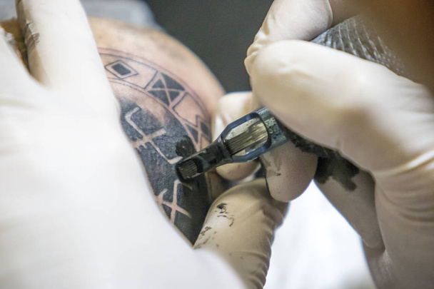 Tattoo session on the shoulder. - Photo, Image