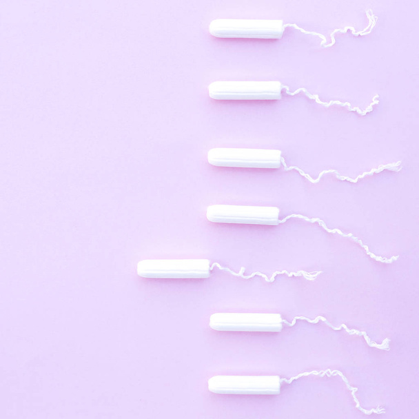 Female tampons for menstruation on a pink background. - Фото, зображення