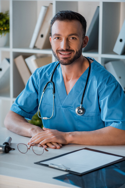 cheerful doctor looking at camera in clinic  - Photo, Image