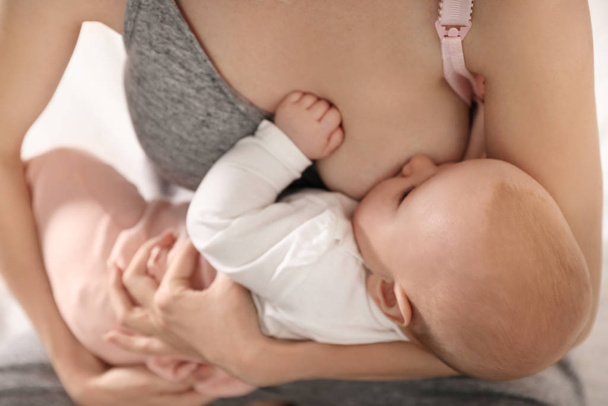 Young woman breast feeding her little baby, closeup - Foto, imagen