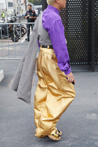 Man with golden glitter trousers and Gucci purple shirt before Fila fashion show, Milan Fashion Week street style  - Фото, изображение