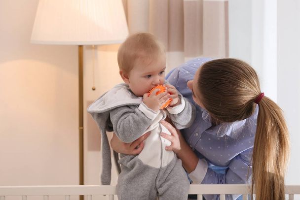 Teen nanny with cute little baby at home - Foto, Bild