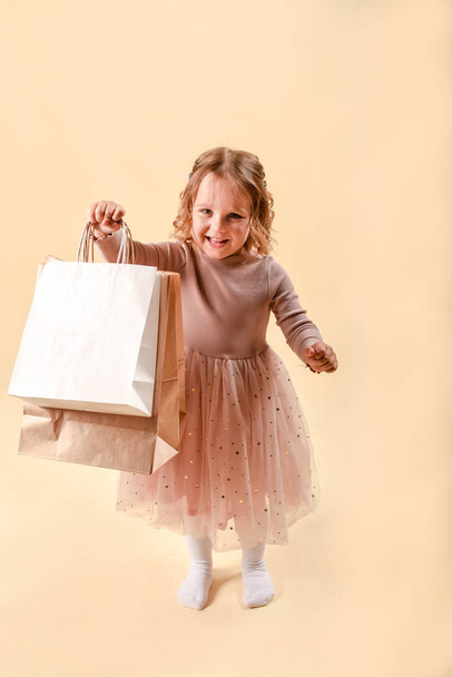 Small fashion girl . happy shopping girl runs with full bags and laughs. black Friday discount. cyber Monday. Present and gifts buy. summer sales. copy space. - Photo, Image