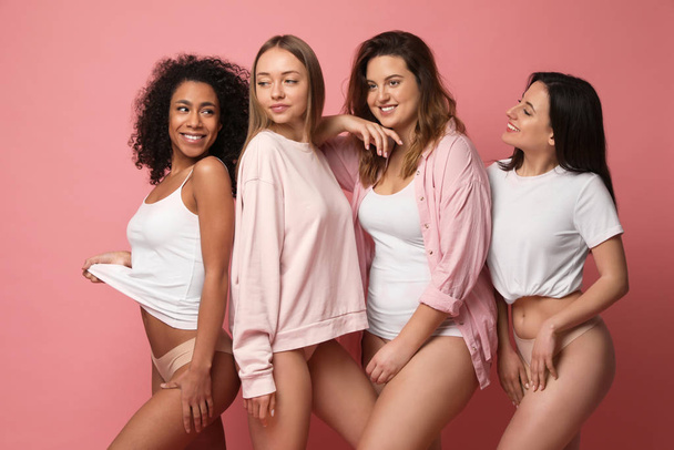 Group of women with different body types in underwear on pink background - Foto, Imagem