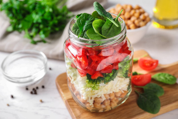 Healthy salad in glass jar on white table - 写真・画像