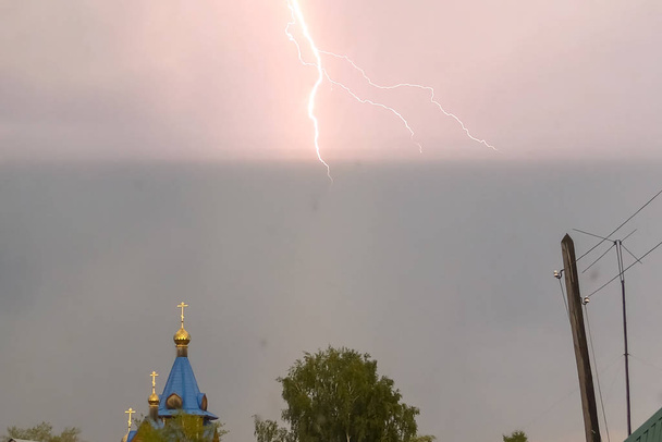 Lightning during a thunderstorm in the sky above the dome and cr - Photo, Image