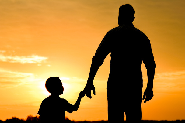 happy dad with a child in the park outdoors silhouette - Photo, Image
