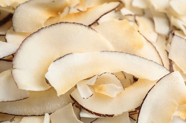 Delicious fresh coconut chips as background, closeup - Valokuva, kuva