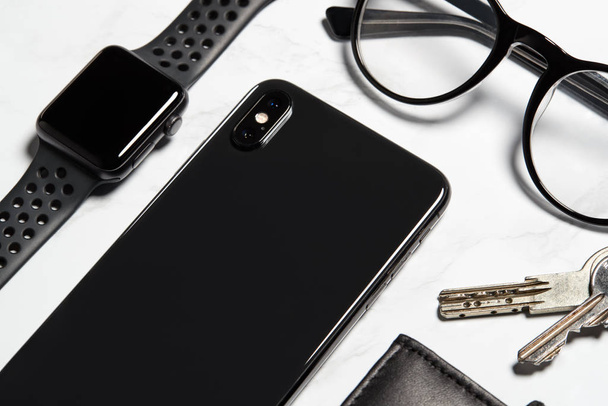Flat Lay Shot Of Techno Items For Modern Worker With Smartwatch Mobile Phone And Glasses - 写真・画像