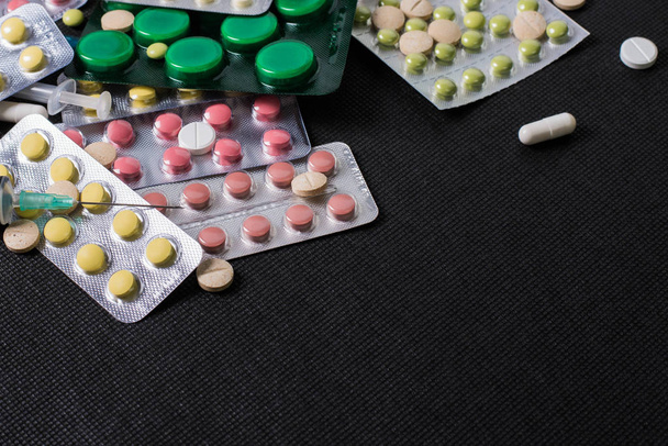 pharmaceuticals antibiotics pills medicine /colorful antibacterials pills on black background /capsule pill medicine. Creative idea. Drugs. Sad. Die. Illness - Photo, Image