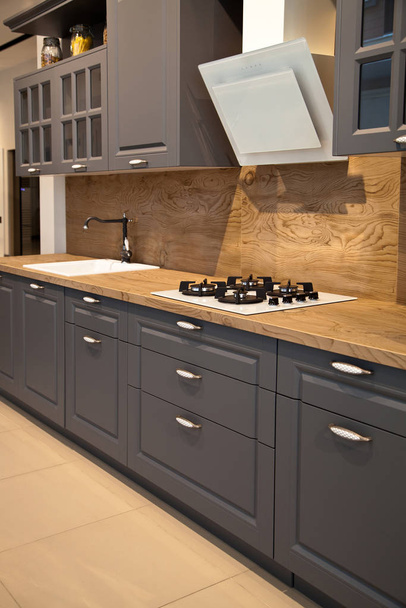 Interior of luxurious wooden modern kitchen grey cabinets - Photo, Image