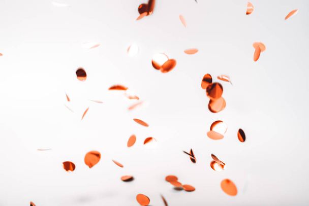 Rose gold falling confetti on white - Φωτογραφία, εικόνα