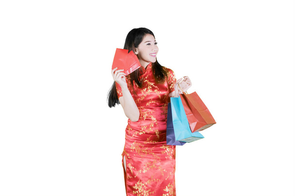 Beautiful Asian woman seeking another clothes - Foto, Imagen