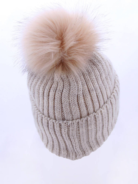 Women's knitted hat isolated on white background..hat with pompom . Beige hat . - 写真・画像