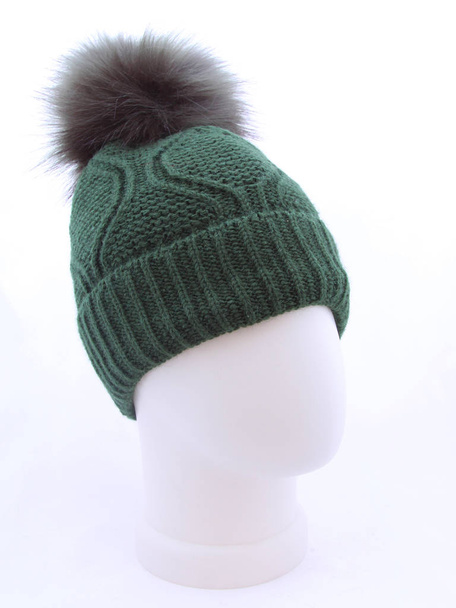 Green knitted hat on mannequin head - 写真・画像
