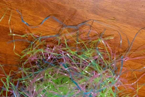 easter grass laying on wooden grain table - Photo, Image