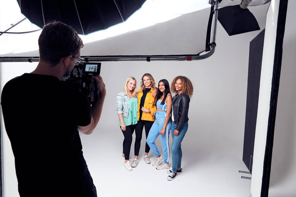 Group Studio Photo Shoot Of Young Multi-Cultural Female Friends Smiling And Laughing At Camera - Foto, imagen