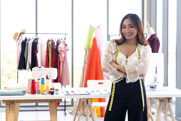 Portrait of young adult fashion designer as owner entrepreneur at her atelier studio. Using for entrepreneur startup concept. - Foto, Imagem