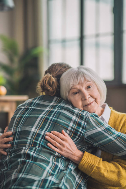 Grey-haired elderly lady feeling happy with her son - Valokuva, kuva