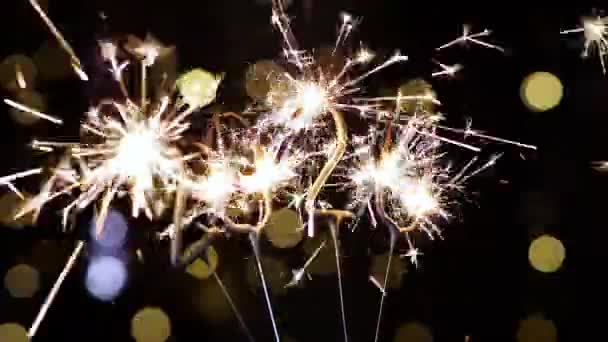 Sparkler in the form of 2020 sparkles brightly sparks against a dark background. - Footage, Video
