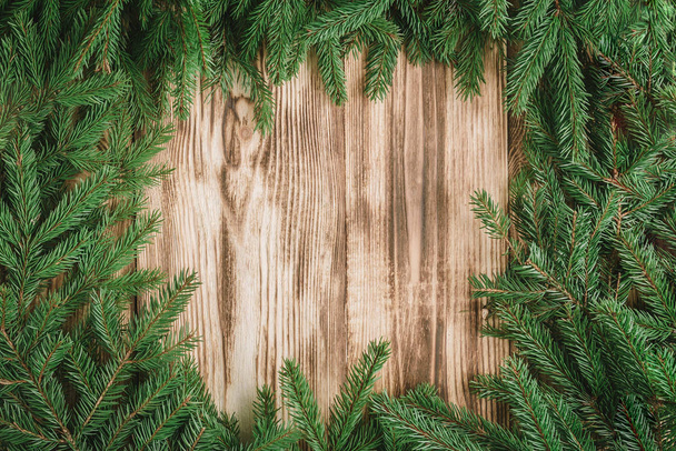 Fir branches on wooden background. - Photo, image