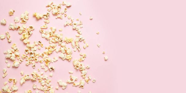 Tasty salty or sweet popcorn border on pink background with copy space. Watching movie, cinema, concept. - Foto, Imagem