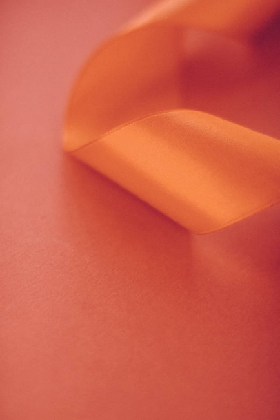 Abstract curly silk ribbon on orange background, exclusive luxur - Photo, Image