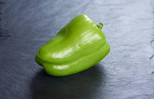 Green sweet bell pepper on a stone background - Photo, image