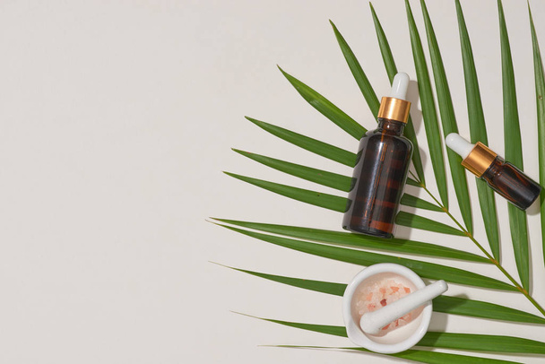 Concepto de spa con, sal de masaje en cuchara y botellas de aceite esencial con licencia pequeña
 - Foto, Imagen