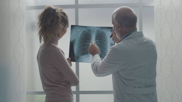 Professional doctor checking a patient's radiography - Foto, Bild
