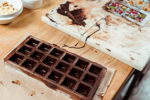 selective focus of chocolate molds with melted chocolate  - Photo, Image