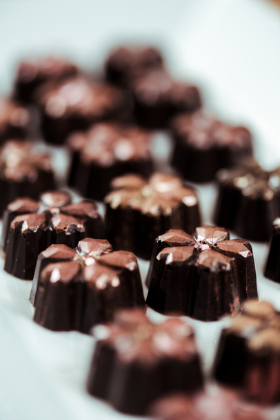 close up of fresh and tasty chocolate candies on plate  - Fotoğraf, Görsel