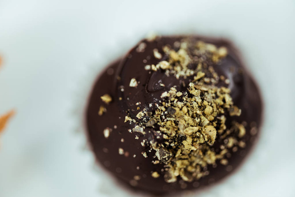 close up of tasty chocolate ball with pistachio powder - Zdjęcie, obraz