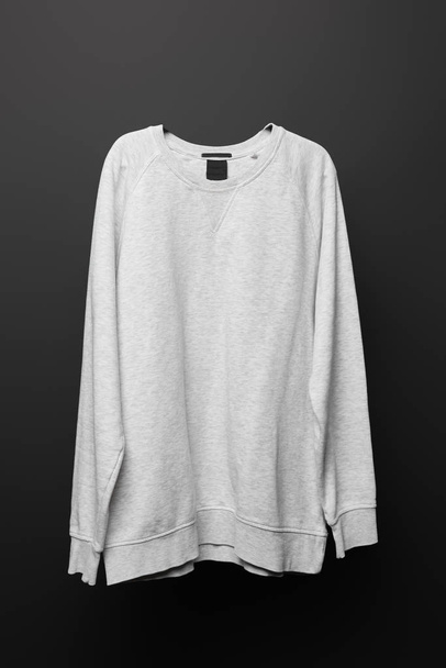 blank basic grey sweatshirt isolated on black  - Fotó, kép