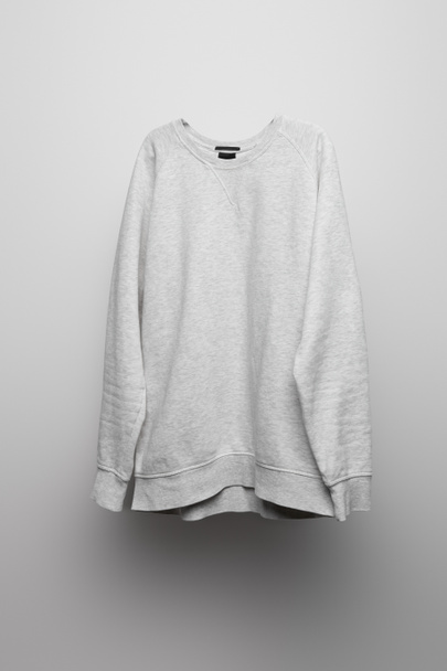 blank basic grey sweatshirt on grey background - Фото, изображение