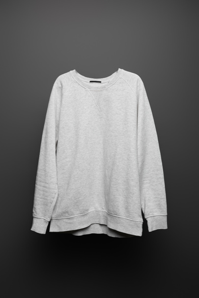 blank basic grey sweatshirt on black background - Фото, изображение
